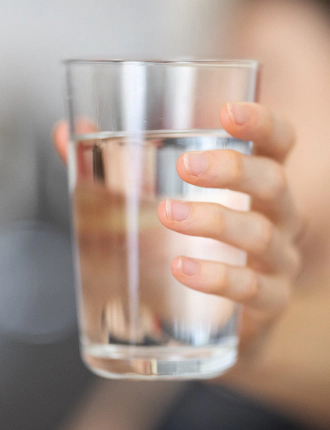 hand holding a glass of water